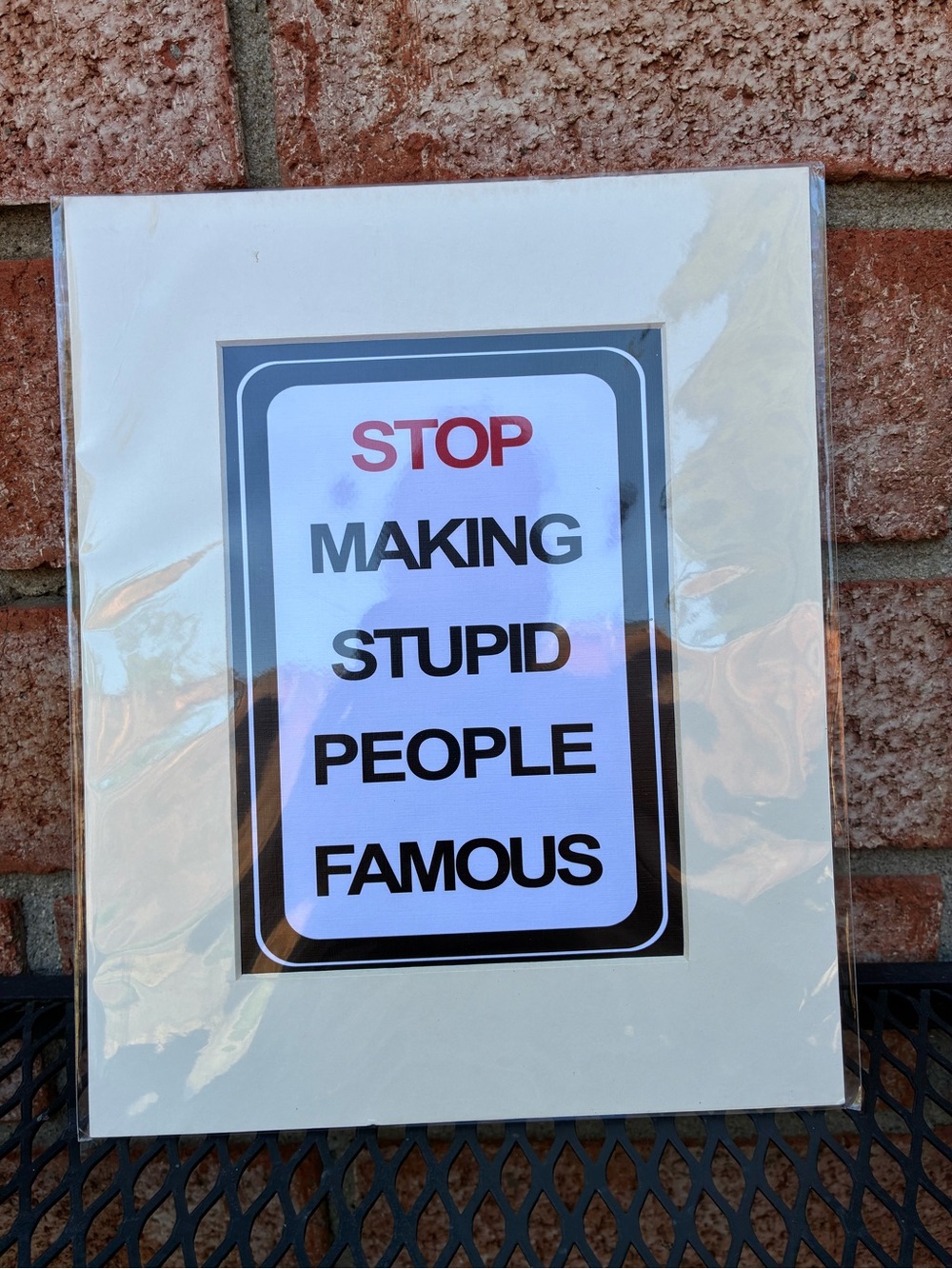 Stop Making Stupid People Famous Sign - White/Black with Red Accent